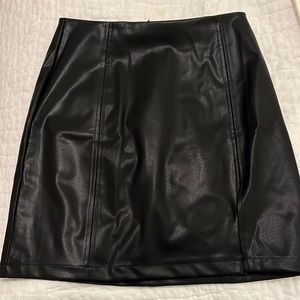 Feaux black leather skirt with slit at the bottom. Size M